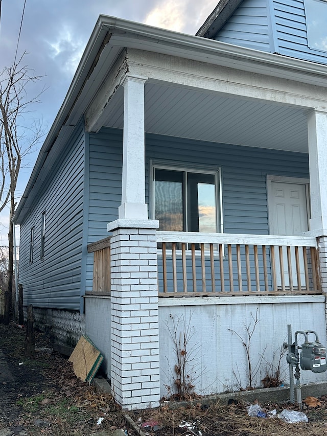 view of side of home with a porch