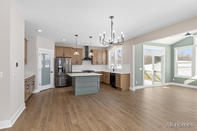 kitchen with black dishwasher, decorative backsplash, wall chimney range hood, stainless steel refrigerator with ice dispenser, and a sink