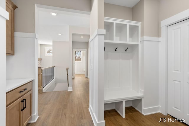 mudroom with light wood-style floors, recessed lighting, and baseboards