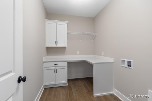 laundry area with hookup for a washing machine, cabinet space, baseboards, and wood finished floors