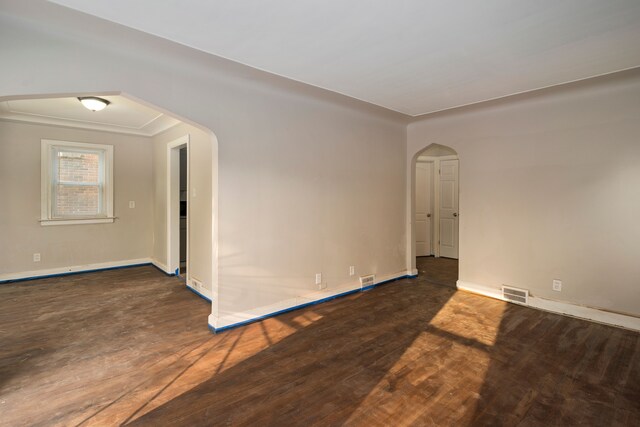 unfurnished room with dark hardwood / wood-style floors and crown molding