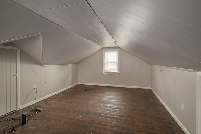 additional living space with dark hardwood / wood-style flooring and lofted ceiling