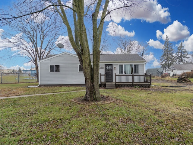 view of front of home featuring a front lawn and a deck