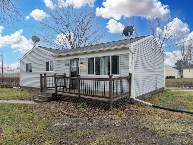 rear view of property with a wooden deck