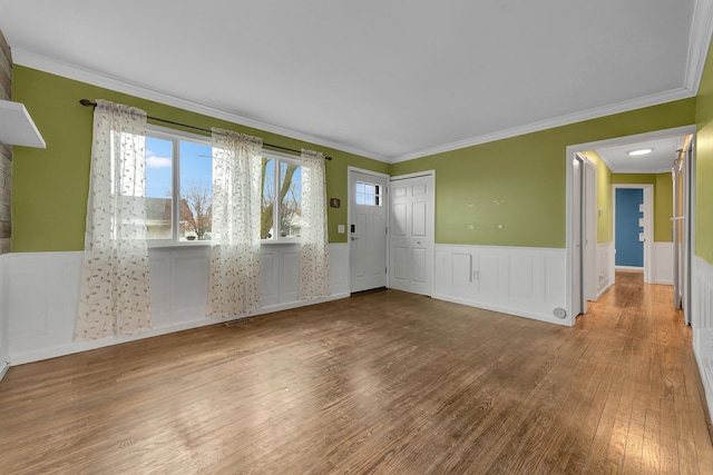 spare room featuring hardwood / wood-style floors and ornamental molding