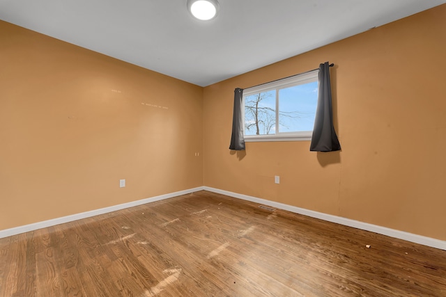 empty room with hardwood / wood-style flooring