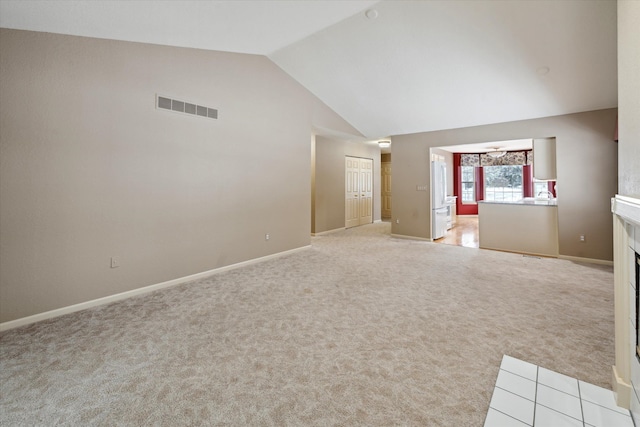 unfurnished living room featuring light carpet and high vaulted ceiling