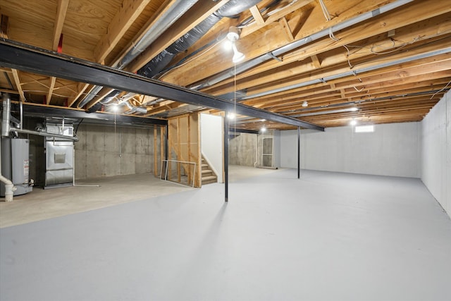 basement with water heater and heating unit