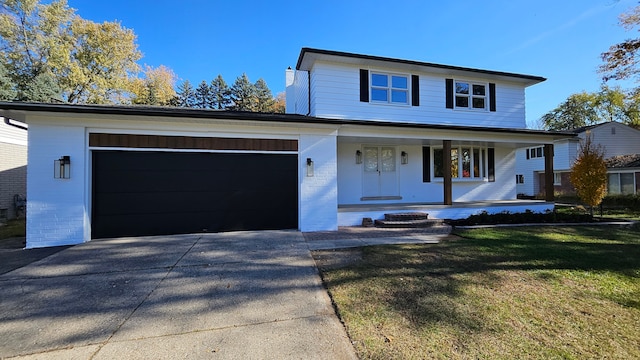 view of front facade featuring a garage, a front lawn, and a porch