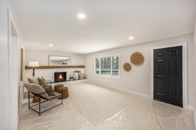 living area with visible vents, baseboards, carpet floors, recessed lighting, and a fireplace