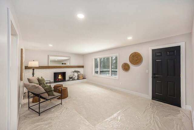 interior space featuring baseboards, recessed lighting, carpet, and a brick fireplace