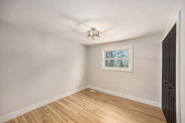 unfurnished bedroom with light wood-style flooring and baseboards