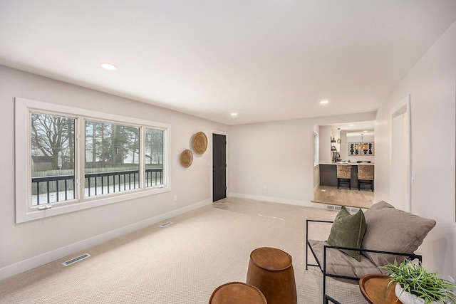 living room with light colored carpet, baseboards, visible vents, and recessed lighting