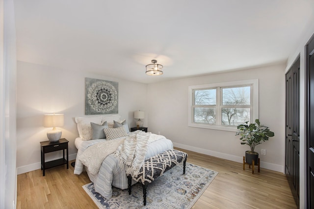 bedroom featuring light wood-style flooring and baseboards