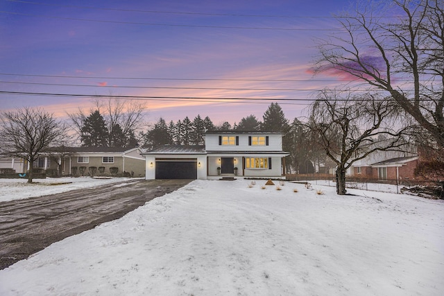 view of front of home featuring a porch and an attached garage