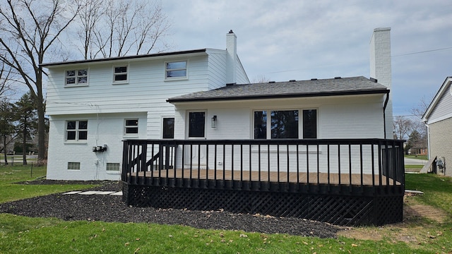 rear view of house with brick siding, a wooden deck, and a chimney