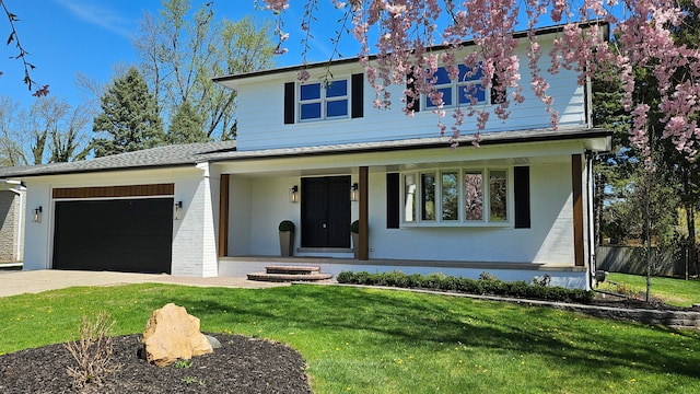 view of front of house featuring covered porch, an attached garage, driveway, and brick siding