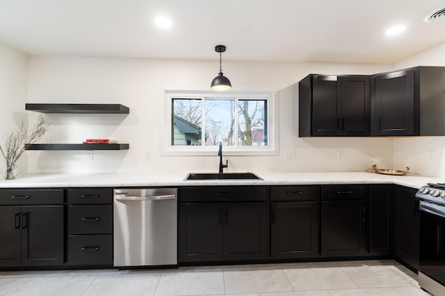 kitchen featuring light tile patterned flooring, decorative light fixtures, stainless steel appliances, and sink