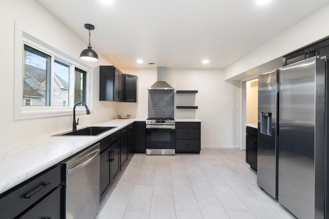 kitchen featuring sink, wall chimney exhaust hood, light stone counters, pendant lighting, and appliances with stainless steel finishes