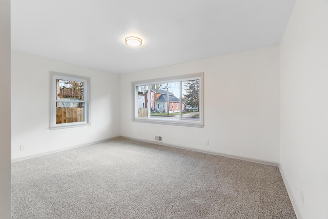 unfurnished room featuring carpet flooring