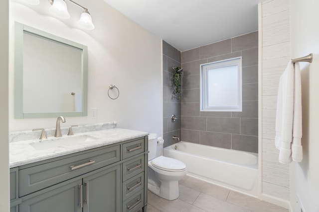 full bathroom featuring tile patterned floors, vanity, toilet, and tiled shower / bath