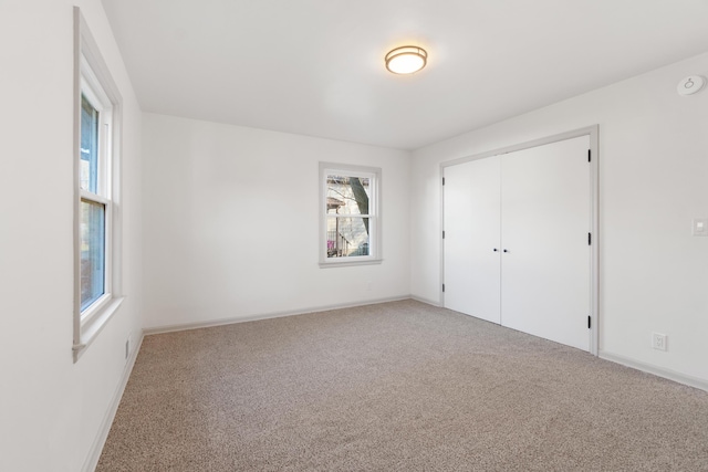 unfurnished bedroom featuring a closet and carpet