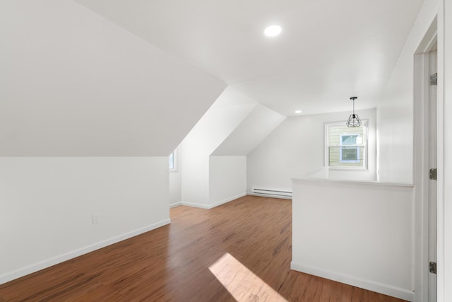 bonus room with hardwood / wood-style floors, a baseboard radiator, and lofted ceiling