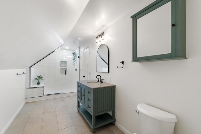 bathroom with tiled shower, tile patterned floors, vanity, and toilet