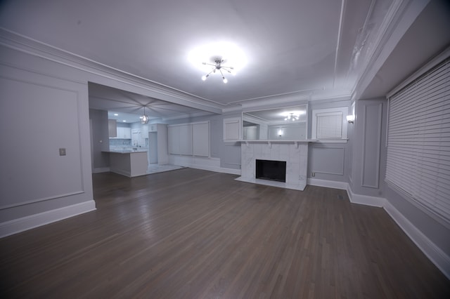 unfurnished living room with a high end fireplace, dark hardwood / wood-style floors, and ornamental molding