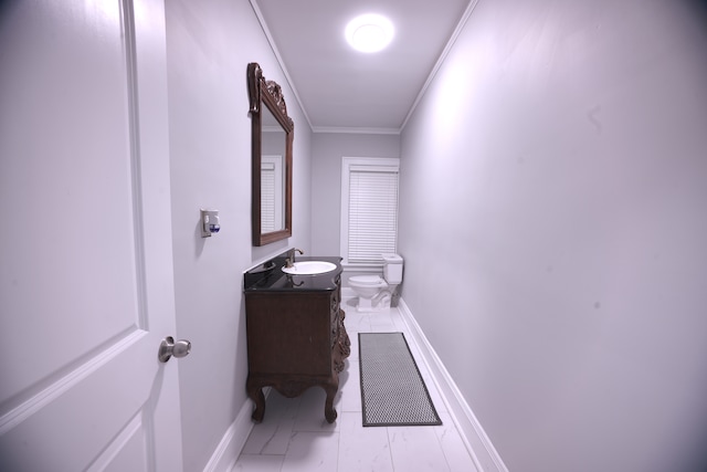 bathroom featuring vanity, toilet, and crown molding