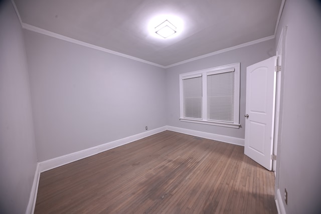 spare room featuring crown molding and wood-type flooring