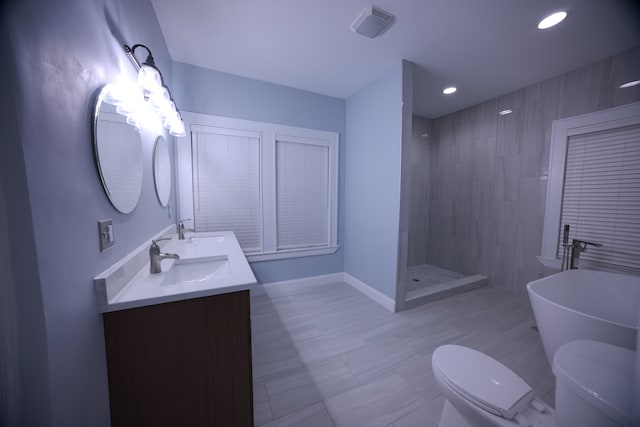 full bathroom featuring shower with separate bathtub, vanity, and toilet