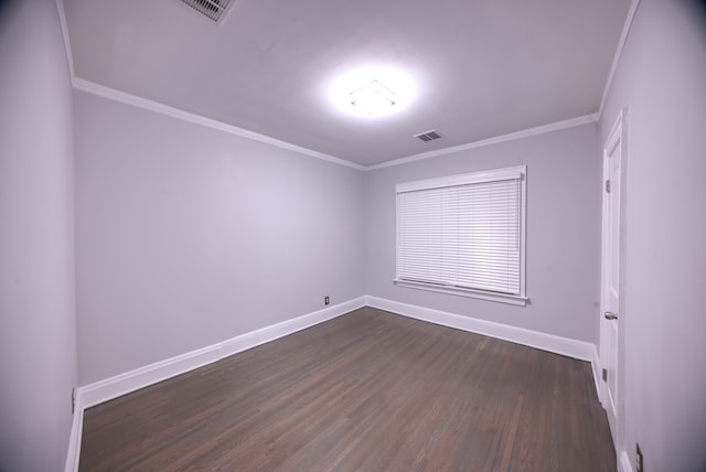 empty room featuring dark hardwood / wood-style floors and ornamental molding