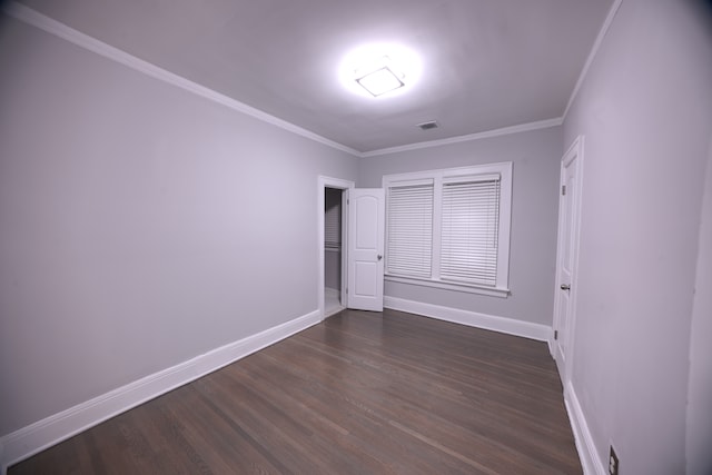 unfurnished bedroom with dark hardwood / wood-style flooring and ornamental molding