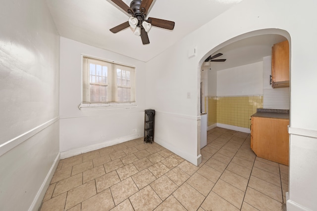 unfurnished room featuring ceiling fan and light tile patterned flooring