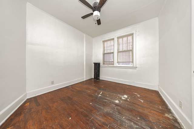 spare room with ceiling fan and dark hardwood / wood-style flooring