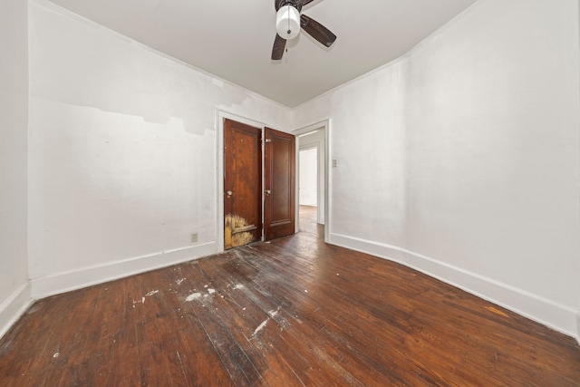 unfurnished bedroom with ceiling fan and dark hardwood / wood-style floors