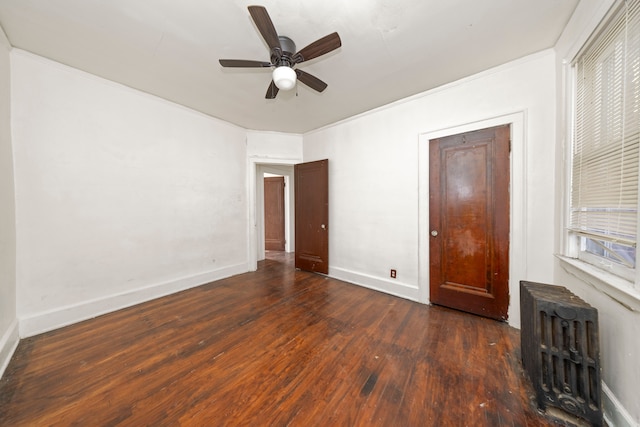 unfurnished bedroom with radiator, ceiling fan, dark wood-type flooring, and ornamental molding