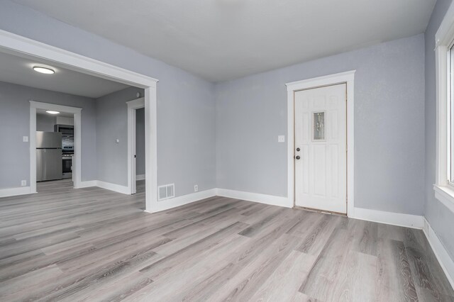 spare room with light hardwood / wood-style flooring