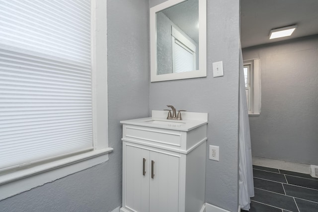 bathroom featuring tile patterned flooring and vanity