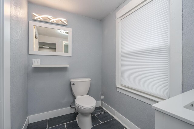 bathroom with tile patterned floors, vanity, and toilet