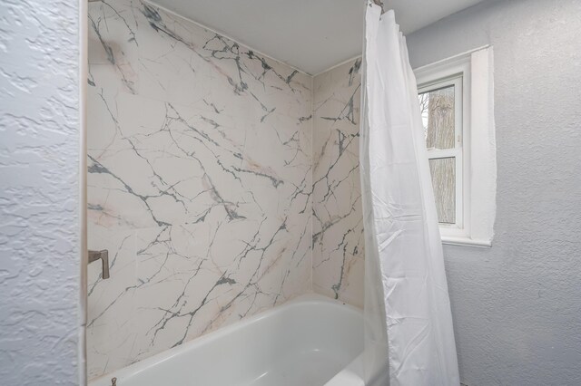 bathroom featuring shower / tub combo with curtain