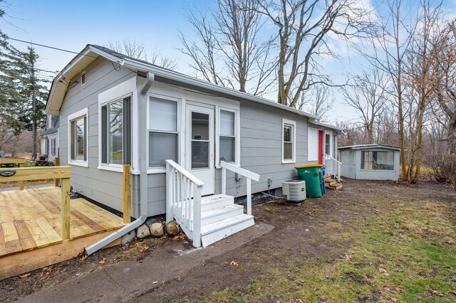 view of front of house featuring central AC and a deck