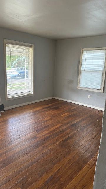 empty room featuring dark hardwood / wood-style flooring