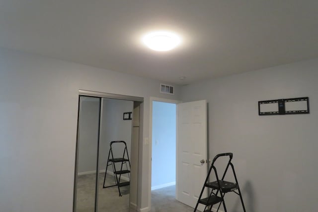 interior space with light colored carpet and a closet