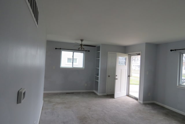 carpeted empty room with ceiling fan