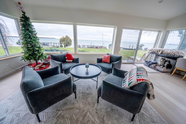 sunroom / solarium featuring a water view and plenty of natural light