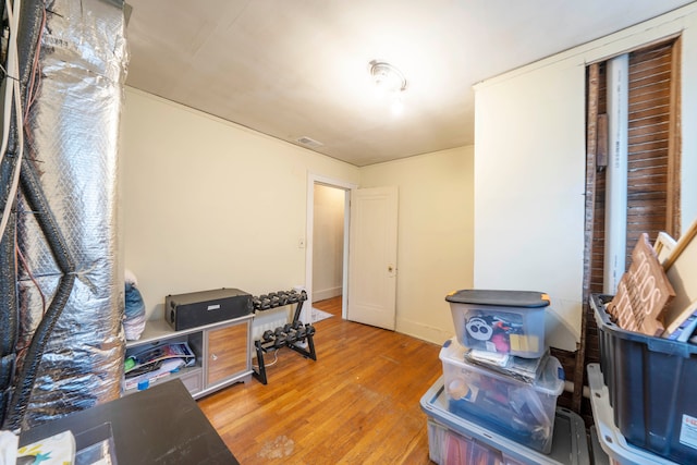 home office with light hardwood / wood-style flooring