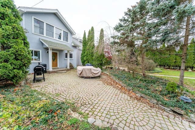 rear view of property featuring a patio