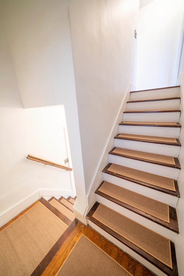 stairs with hardwood / wood-style flooring